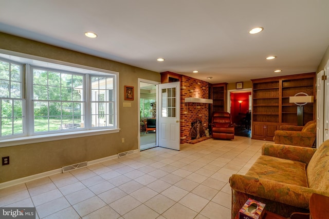 living room featuring light tile patterned flooring, recessed lighting, and baseboards