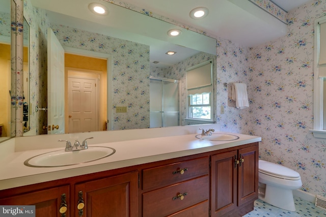 full bath featuring a stall shower, wallpapered walls, recessed lighting, toilet, and double vanity