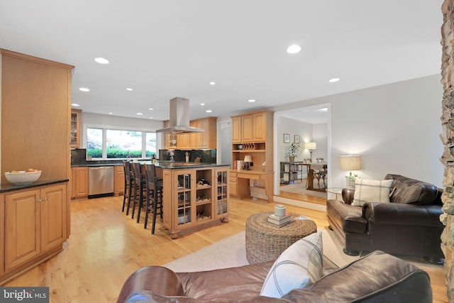 living room with light wood-type flooring and recessed lighting