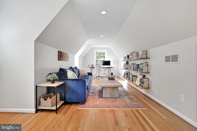 living area with wood finished floors, baseboards, lofted ceiling, an office area, and recessed lighting
