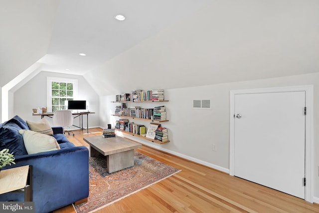 living area featuring lofted ceiling, wood finished floors, an office area, baseboards, and recessed lighting