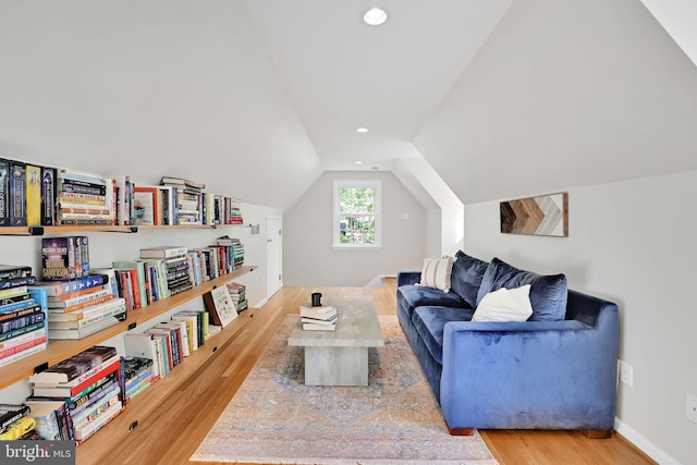 living area featuring wood finished floors, lofted ceiling, and recessed lighting