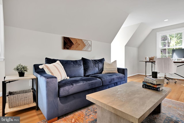 living area with light wood-style flooring and lofted ceiling