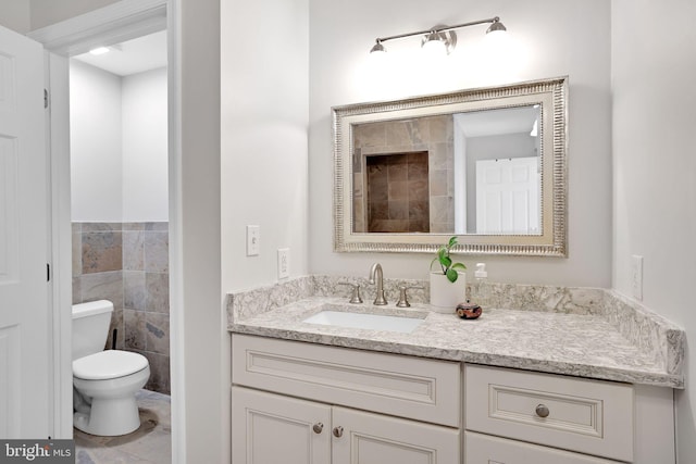 bathroom featuring toilet and vanity