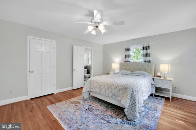 bedroom with light wood-style flooring, baseboards, and ceiling fan