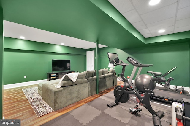workout room featuring wood finished floors, baseboards, and recessed lighting