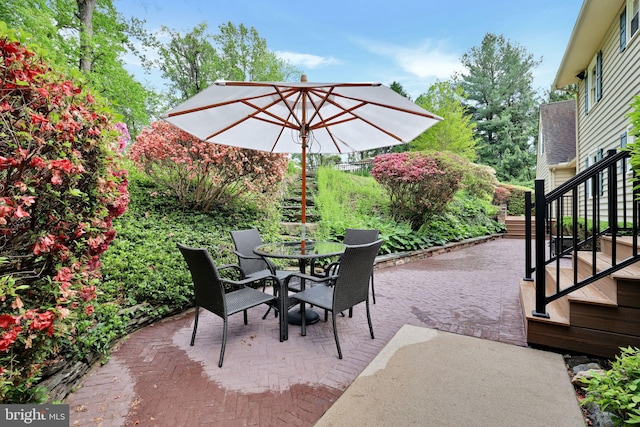 view of patio with stairway and outdoor dining area