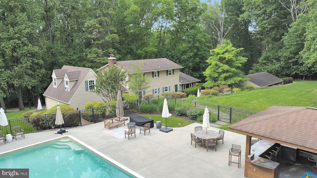 view of swimming pool with a patio, an outdoor fire pit, and outdoor dining space