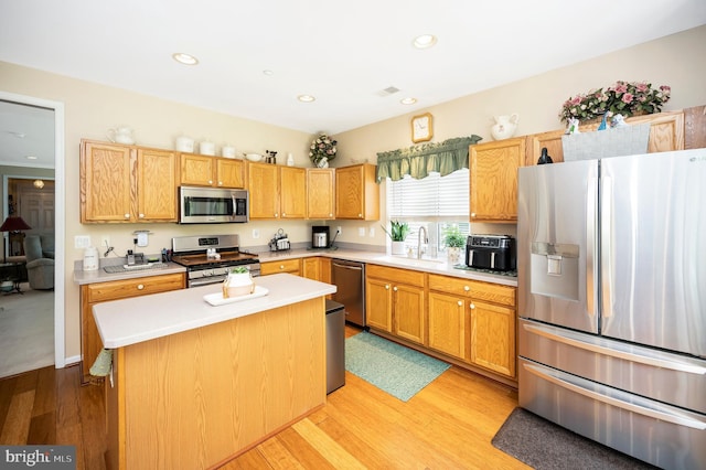 24 Smithfield Way, Fredericksburg, VA 22406 - kitchen featuring appliances with stainless steel finishes, light countertops, light wood-style floors, a kitchen island, and recessed lighting