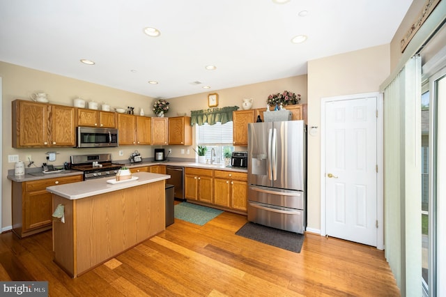 24 Smithfield Way, Fredericksburg, VA 22406 - kitchen with appliances with stainless steel finishes, light countertops, a center island, light wood-style flooring, and recessed lighting