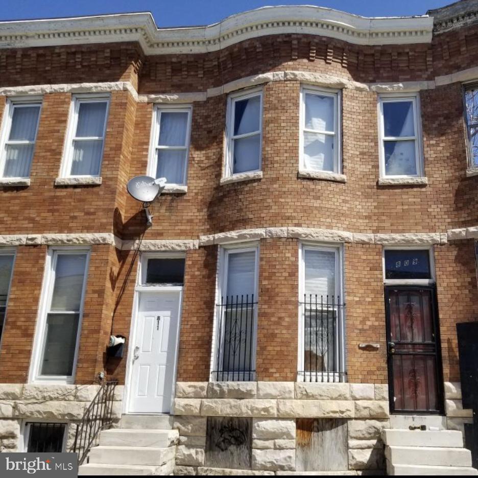 view of property with entry steps and brick siding