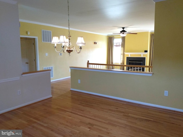 1372 Summerswood Dr, Saint Thomas, PA 17252 - unfurnished living room featuring baseboards, wood finished floors, crown molding, a chandelier, and a ceiling fan