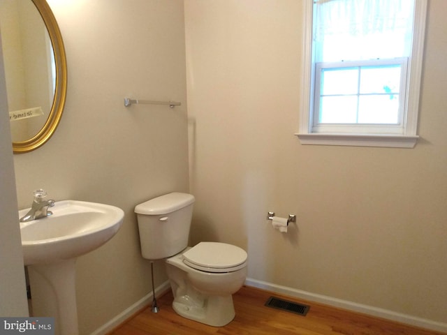 1372 Summerswood Dr, Saint Thomas, PA 17252 - half bathroom with toilet, wood finished floors, baseboards, and a sink