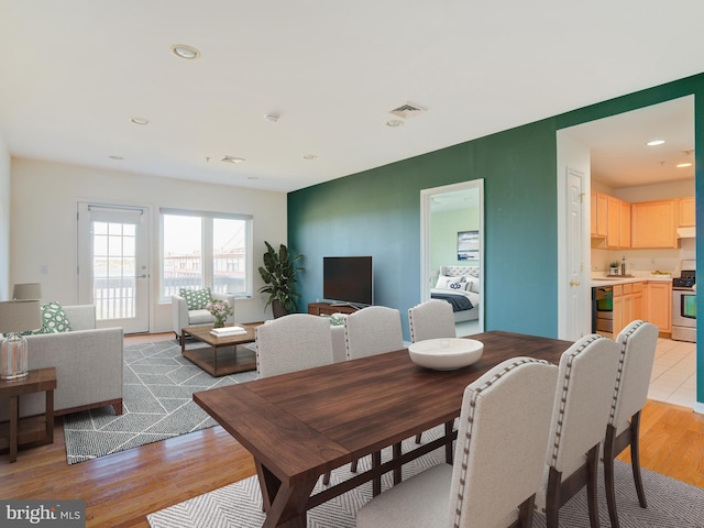 dining room featuring light wood-style floors and recessed lighting