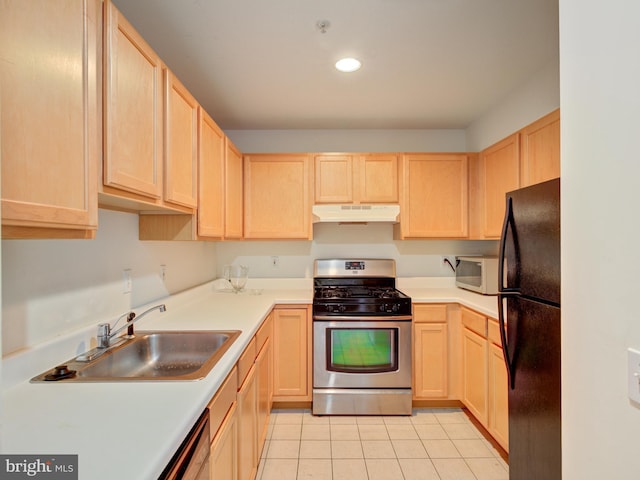 kitchen featuring light brown cabinets, stainless steel range with gas stovetop, freestanding refrigerator, under cabinet range hood, and recessed lighting