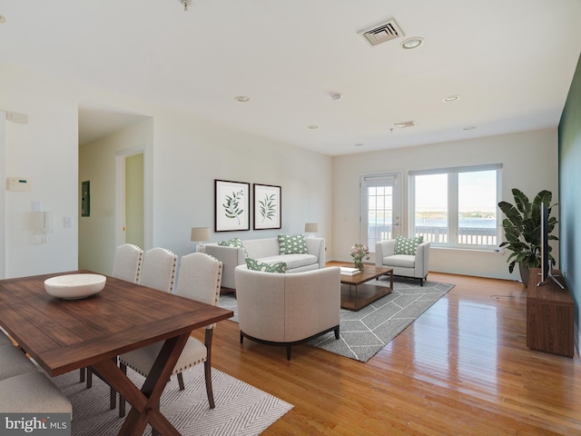 living area with light wood-style floors and recessed lighting