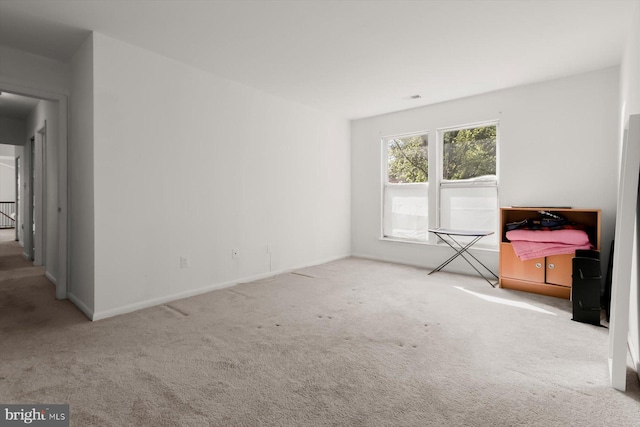empty room with carpet flooring and baseboards