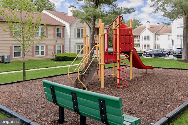 community playground featuring cooling unit, a yard, and a residential view