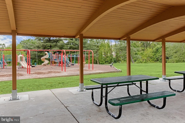 community playground with a yard and a patio