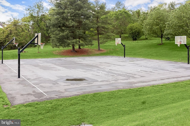view of sport court with community basketball court and a lawn