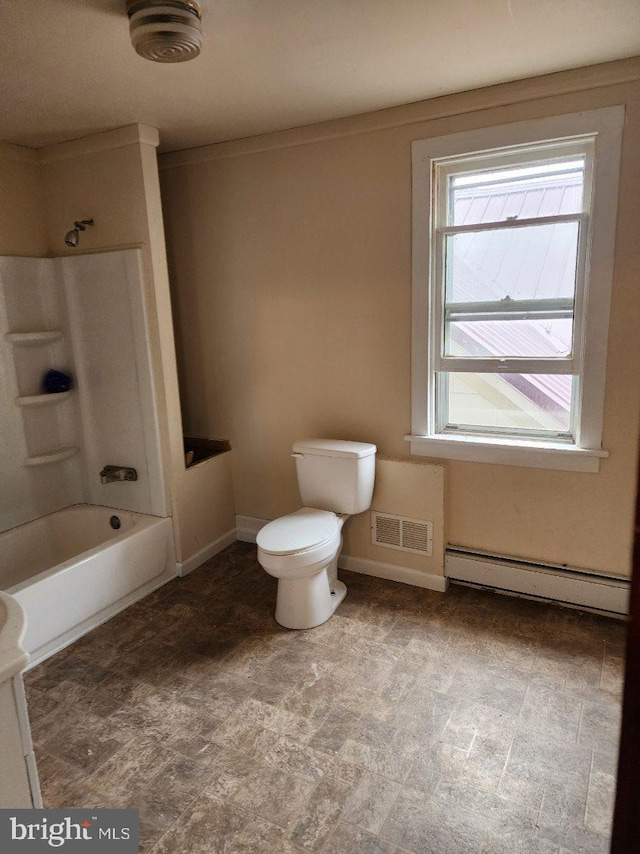 bathroom with a baseboard radiator, healthy amount of natural light, toilet, and baseboards