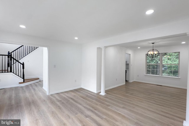 8916 Gladeside Dr, Clinton, MD 20735 - unfurnished living room featuring light wood-type flooring, recessed lighting, stairs, and a chandelier