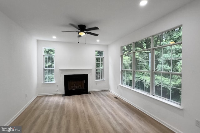8916 Gladeside Dr, Clinton, MD 20735 - unfurnished living room with wood finished floors, a ceiling fan, a fireplace with flush hearth, and recessed lighting