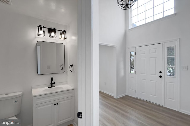 8916 Gladeside Dr, Clinton, MD 20735 - bathroom featuring vanity, wood finished floors, a high ceiling, and a chandelier