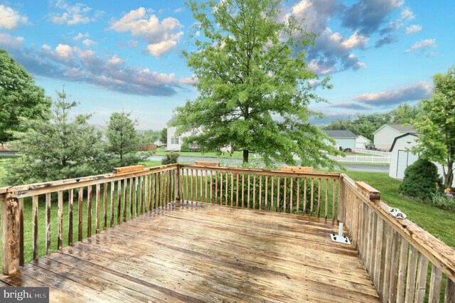 wooden terrace with a lawn