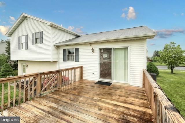 wooden terrace featuring a lawn