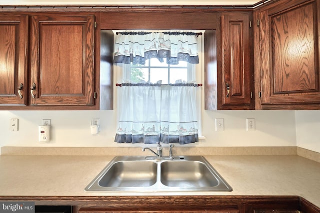kitchen featuring a sink and light countertops