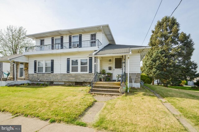 2243 2nd St, Easton, PA 18042 - view of front facade with a balcony, a front lawn, and stone siding
