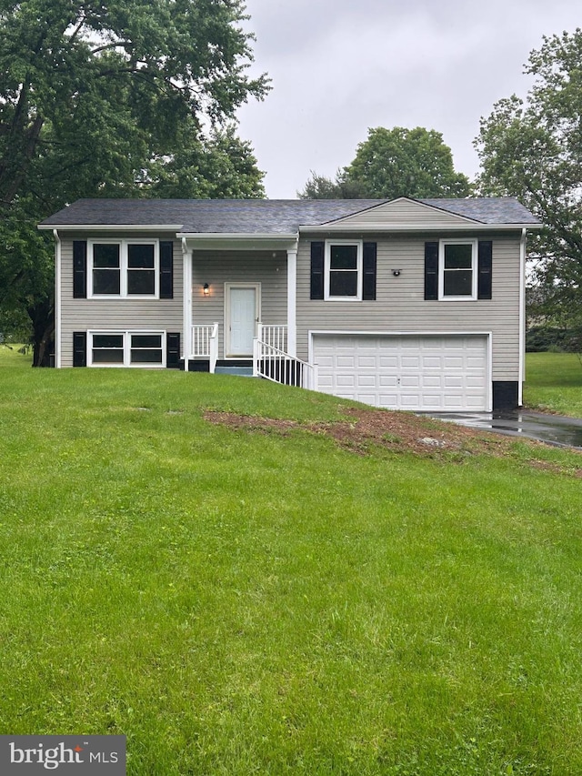 133 Meadowlark Ln, Shepherdstown, WV 25443 - bi-level home featuring an attached garage, asphalt driveway, a front lawn, and covered porch