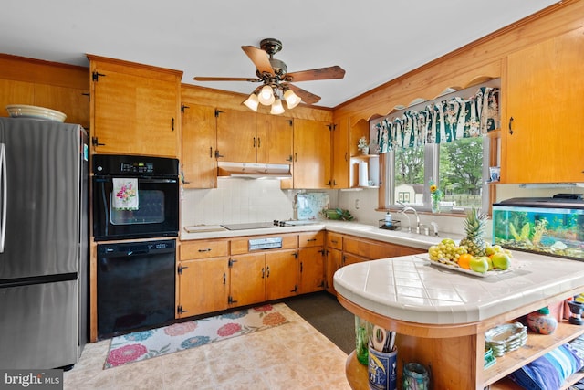 1 Somerset Ave, Cambridge, MD 21613 - kitchen with black appliances, under cabinet range hood, a sink, ceiling fan, and tasteful backsplash