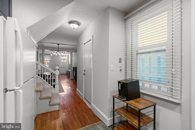 117 E Clement St, Baltimore, MD 21230 - corridor with wood finished floors, stairs, baseboards, and a chandelier