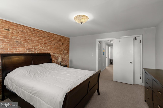 117 E Clement St, Baltimore, MD 21230 - bedroom featuring brick wall and light carpet