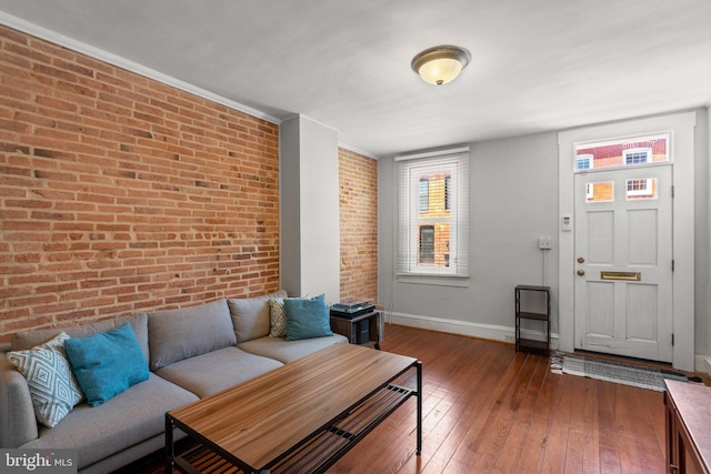 117 E Clement St, Baltimore, MD 21230 - living area featuring brick wall, baseboards, and wood-type flooring