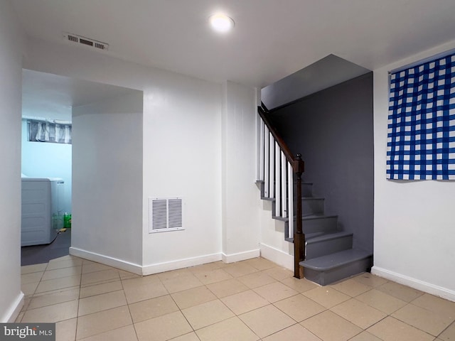 7020 Taylor Ter, Hyattsville, MD 20784 - stairway with washer / dryer, baseboards, and tile patterned flooring