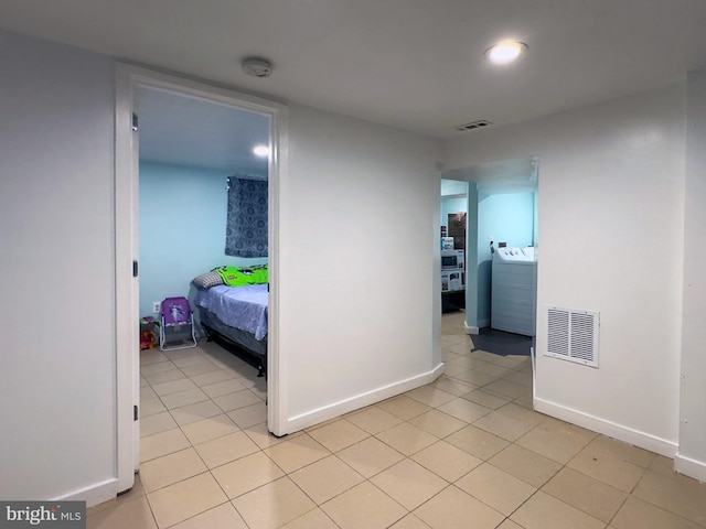 7020 Taylor Ter, Hyattsville, MD 20784 - hallway featuring washer / clothes dryer, baseboards, and light tile patterned flooring