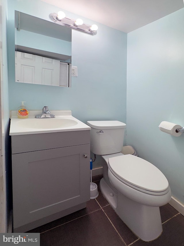 7020 Taylor Ter, Hyattsville, MD 20784 - half bath featuring toilet, vanity, baseboards, and tile patterned floors