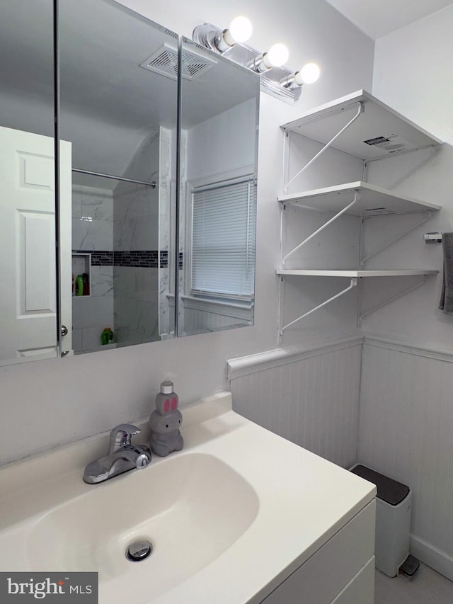 7020 Taylor Ter, Hyattsville, MD 20784 - bathroom featuring vanity, a shower, and a wainscoted wall