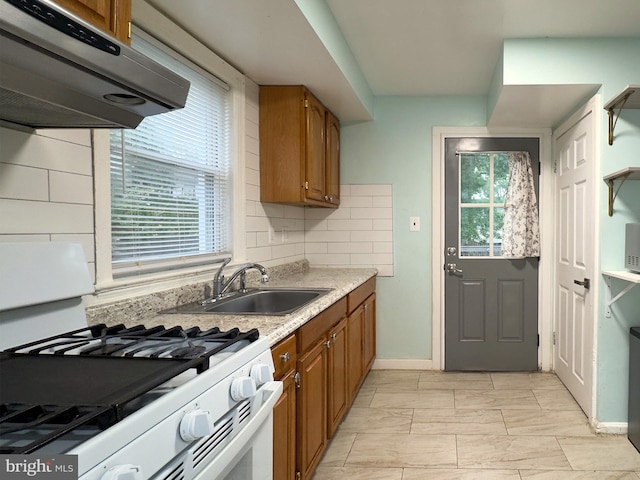 7020 Taylor Ter, Hyattsville, MD 20784 - kitchen with gas range gas stove, range hood, a sink, brown cabinets, and light countertops