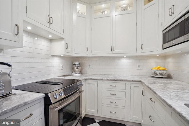 300 S Columbus St, Alexandria, VA 22314 - kitchen with stainless steel appliances, white cabinetry, and decorative backsplash