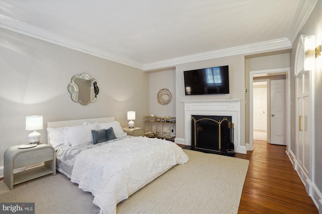 300 S Columbus St, Alexandria, VA 22314 - bedroom with ornamental molding, wood-type flooring, a fireplace with flush hearth, and baseboards