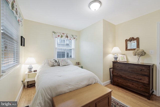 bedroom featuring baseboards and light wood-style floors