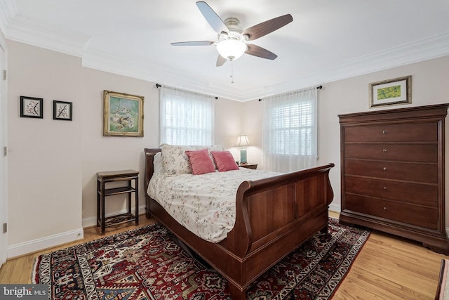bedroom with crown molding, light wood-type flooring, baseboards, and ceiling fan
