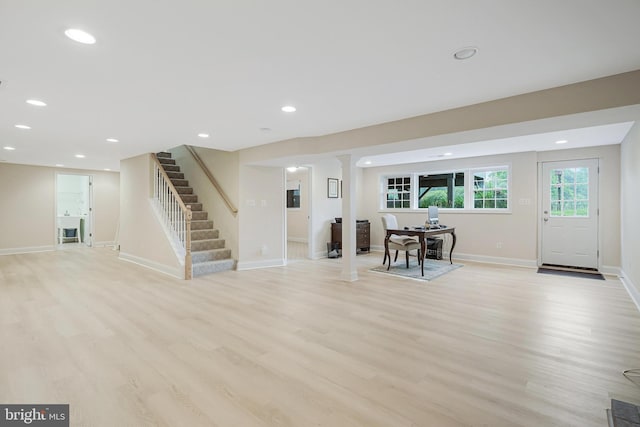 foyer featuring light wood-style floors, stairs, baseboards, and recessed lighting