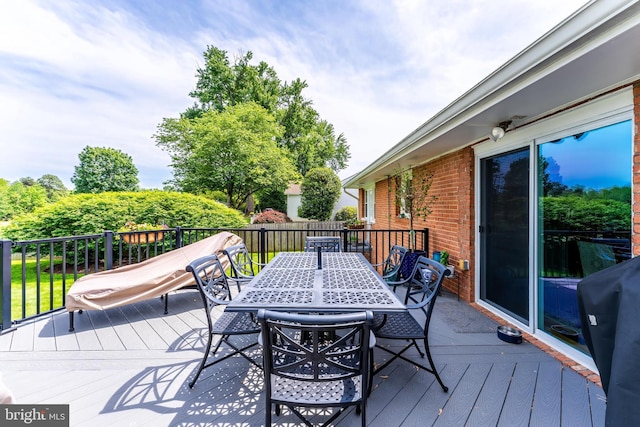 wooden deck featuring outdoor dining space