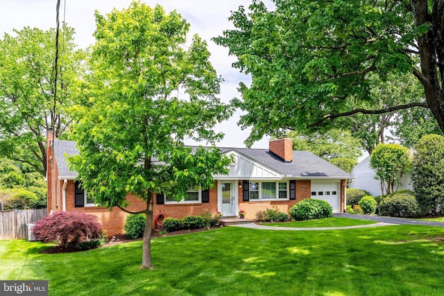 view of front facade with a chimney, brick siding, a garage, and asphalt driveway