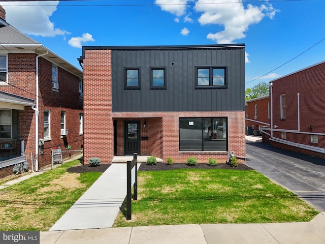 555 Carlisle St, Hanover, PA 17331 - view of front of house with board and batten siding, brick siding, and a front yard